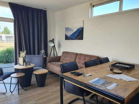 Veluwemeer 2022: Wohnbereich des Ferienhauses mit Esstisch, Sofa und Blick zur Terrasse